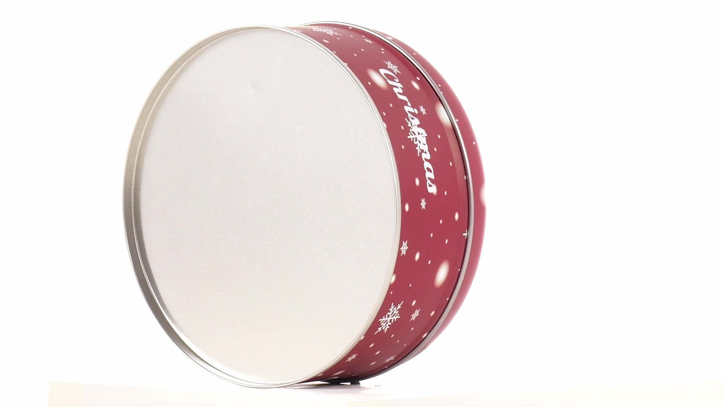 Round red metal tin with Christmas reindeer pattern